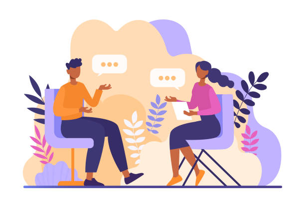 Two people sitting down facing each other to have a conversation.  
